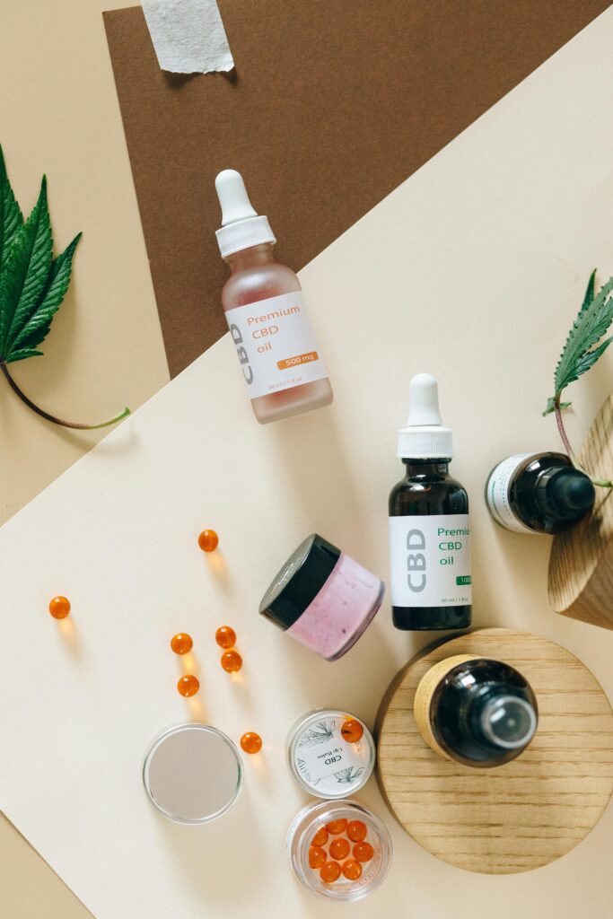 pexels-photo-7852738-7852738 Arrangement of CBD oils, capsules, and leaves on a colorful background.